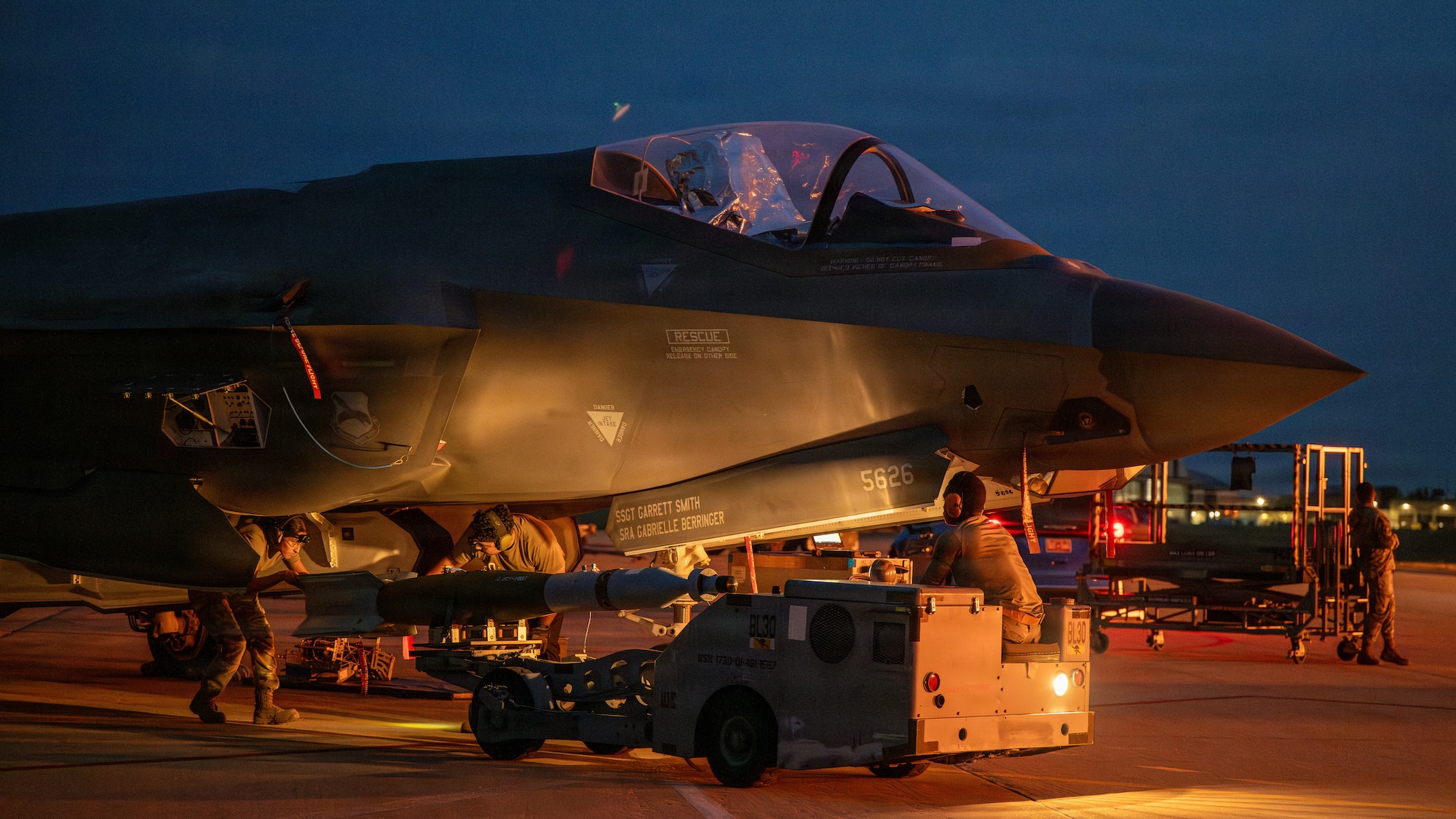 U.S. Airmen assigned to the 325th Aircraft Maintenance Squadron download a munition from an F-35A Lightning II aircraft during Weapons System Evaluation Program-Combat Hammer 26.07 at Hill Air Force Base, Utah, Aug. 12, 2026.