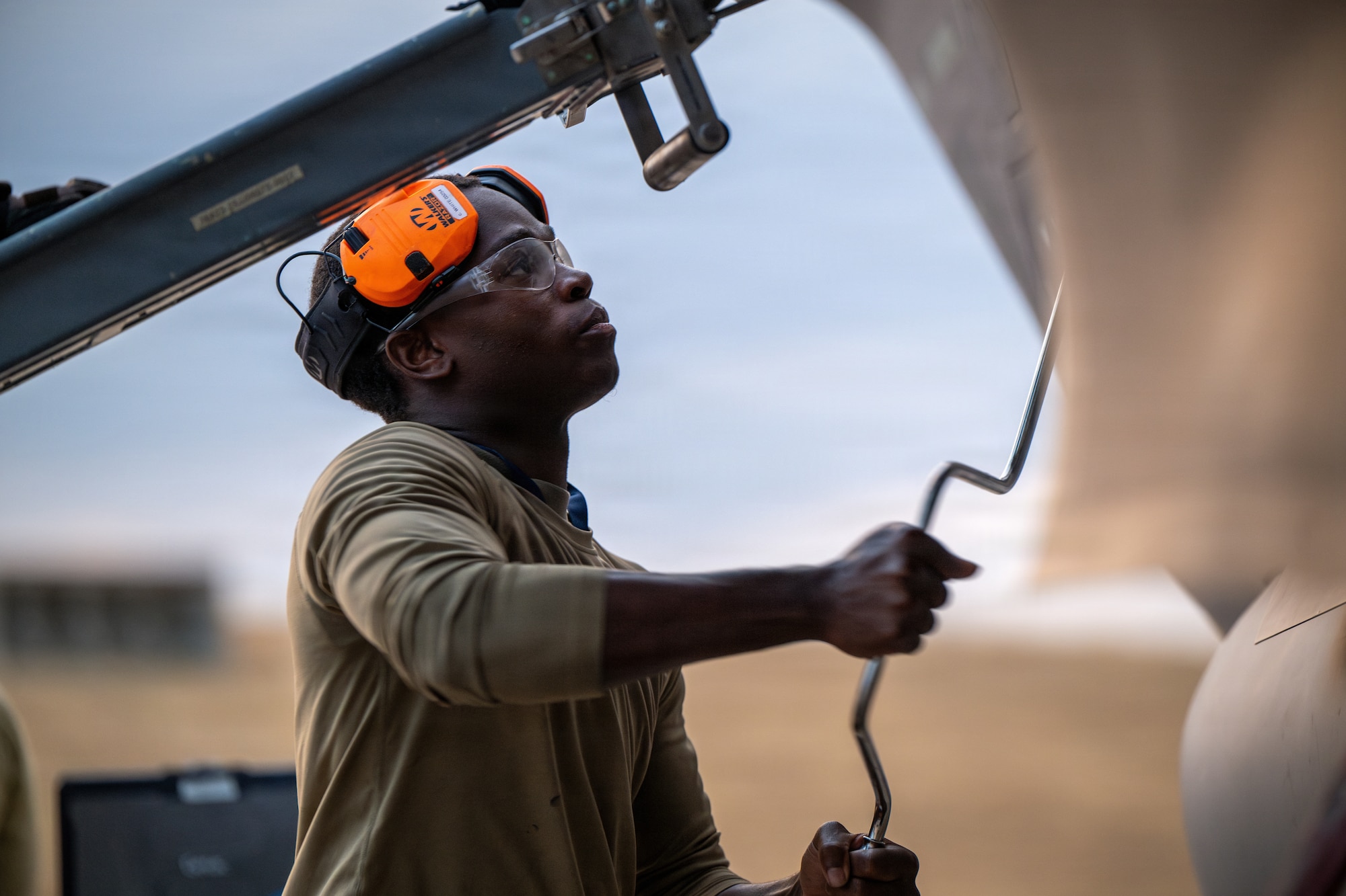 U.S. Air Force Airman 1st Class Caiden White, 325th Aircraft Maintenance Squadron weapons load crew member, uses a handgun to download unexpended ammunition during Weapons System Evaluation Program-Combat Hammer 26.07 at Hill Air Force Base, Utah, Aug. 12, 2026.