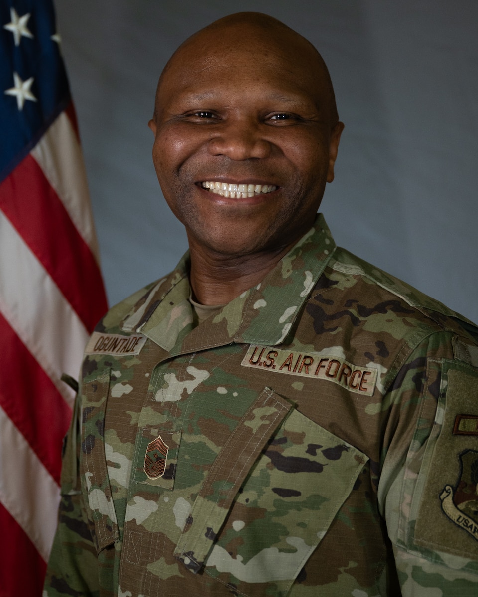Official Air Force photo: grey background, three point lighting, and American flag on stand.