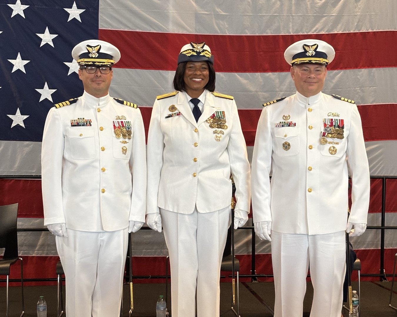 Three members pose for picture.