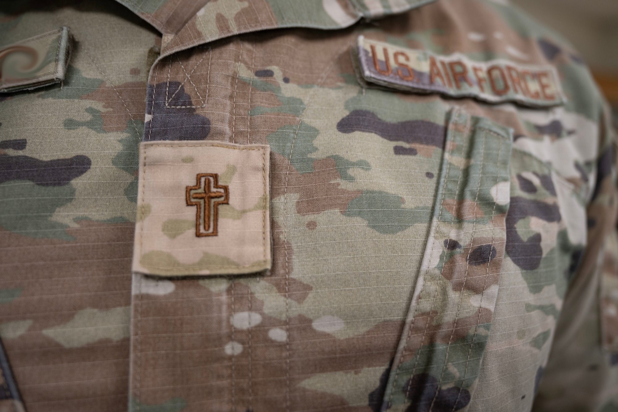 A chaplain assigned to the 1st Special Operations Wing wears a religious insignia on his chest.