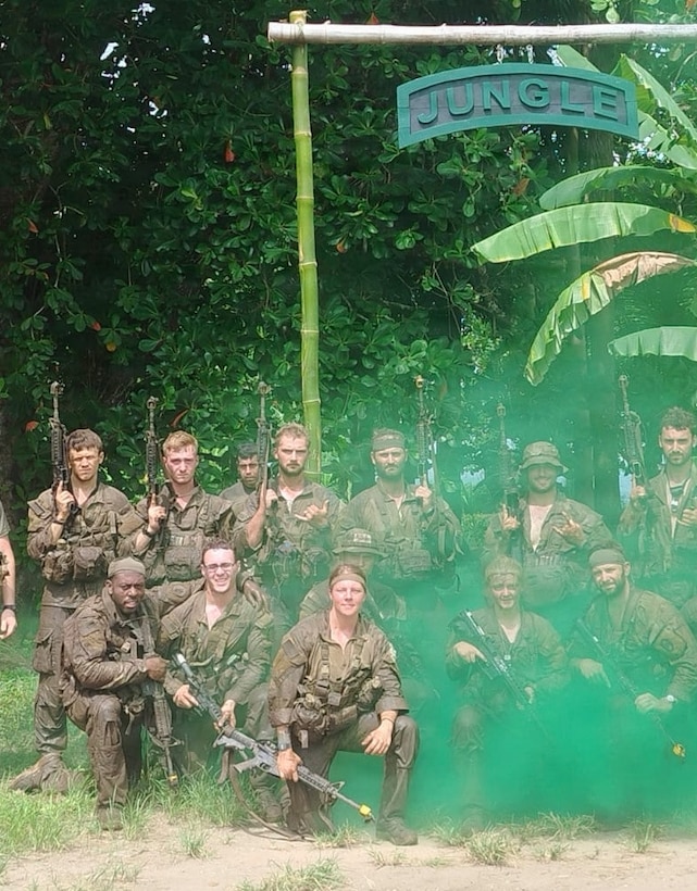 Soldiers pose for a group photo under the Jungle Operations Training sign in Panama June 17.