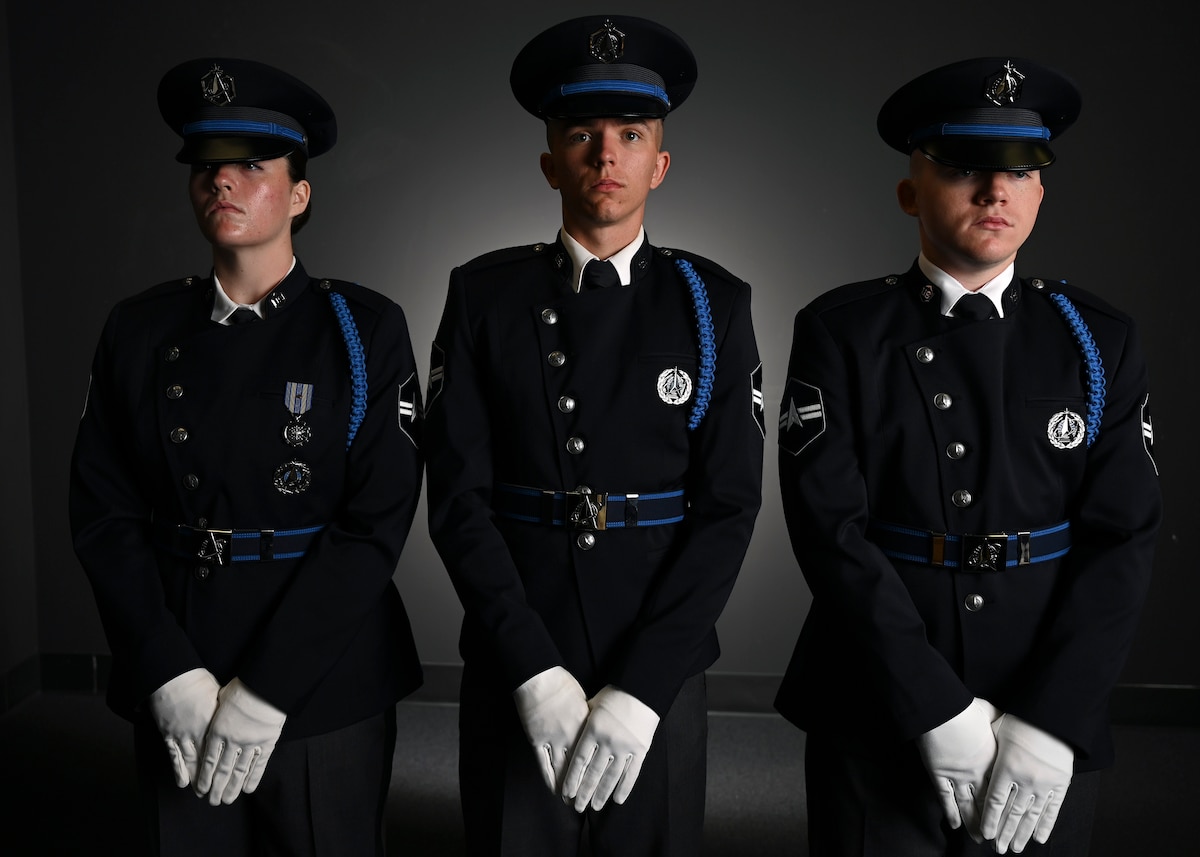 From left, U.S. Space Force Spc. 3 Amelia Olsen, Spc. 3 Dylan Lee, and Spc. 3 Logan Bergstrom, ceremonial guardsmen with the U. S. Space Force Honor Guard, model the new Honor Guard ceremonial uniforms at Joint Base Anacostia-Bolling, Washington, D.C., Aug. 21, 2026. The new uniform was designed to replace the modified U.S. Air Force service uniform Guardians wore when the branch was first established in 2019. (U.S. Air Force photo by Senior Airman Shanel Toussaint)