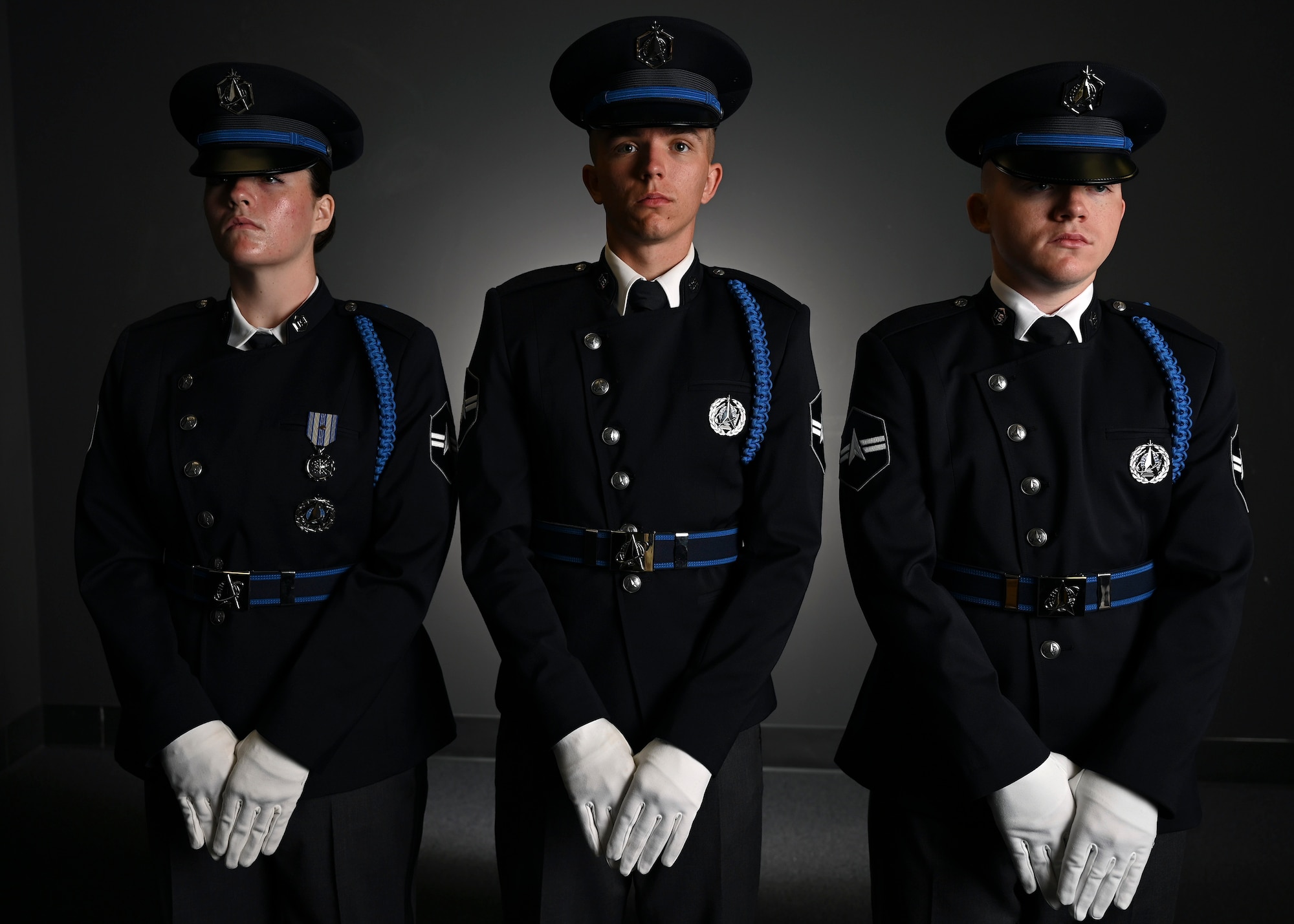 From left, U.S. Space Force Spc. 3 Amelia Olsen, Spc. 3 Dylan Lee, and Spc. 3 Logan Bergstrom, ceremonial guardsmen with the U. S. Space Force Honor Guard, model the new Honor Guard ceremonial uniforms at Joint Base Anacostia-Bolling, Washington, D.C., Aug. 21, 2026. The new uniform was designed to replace the modified U.S. Air Force service uniform Guardians wore when the branch was first established in 2019. (U.S. Air Force photo by Senior Airman Shanel Toussaint)