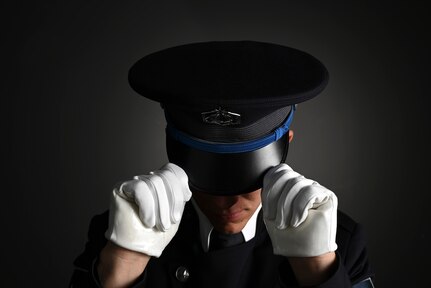 U.S. Space Force Spc. 3 Dylan Lee, ceremonial guardsman with the U.S. Space Force Honor Guard, dons the new Honor Guard ceremonial cap at Joint Base Anacostia-Bolling, Washington, D.C., Aug. 21, 2026. The updated uniform features a distinct Space Force blue belt, cap, and rope over the left shoulder. (U.S. Air Force Photo by Senior Airman Shanel Toussaint)