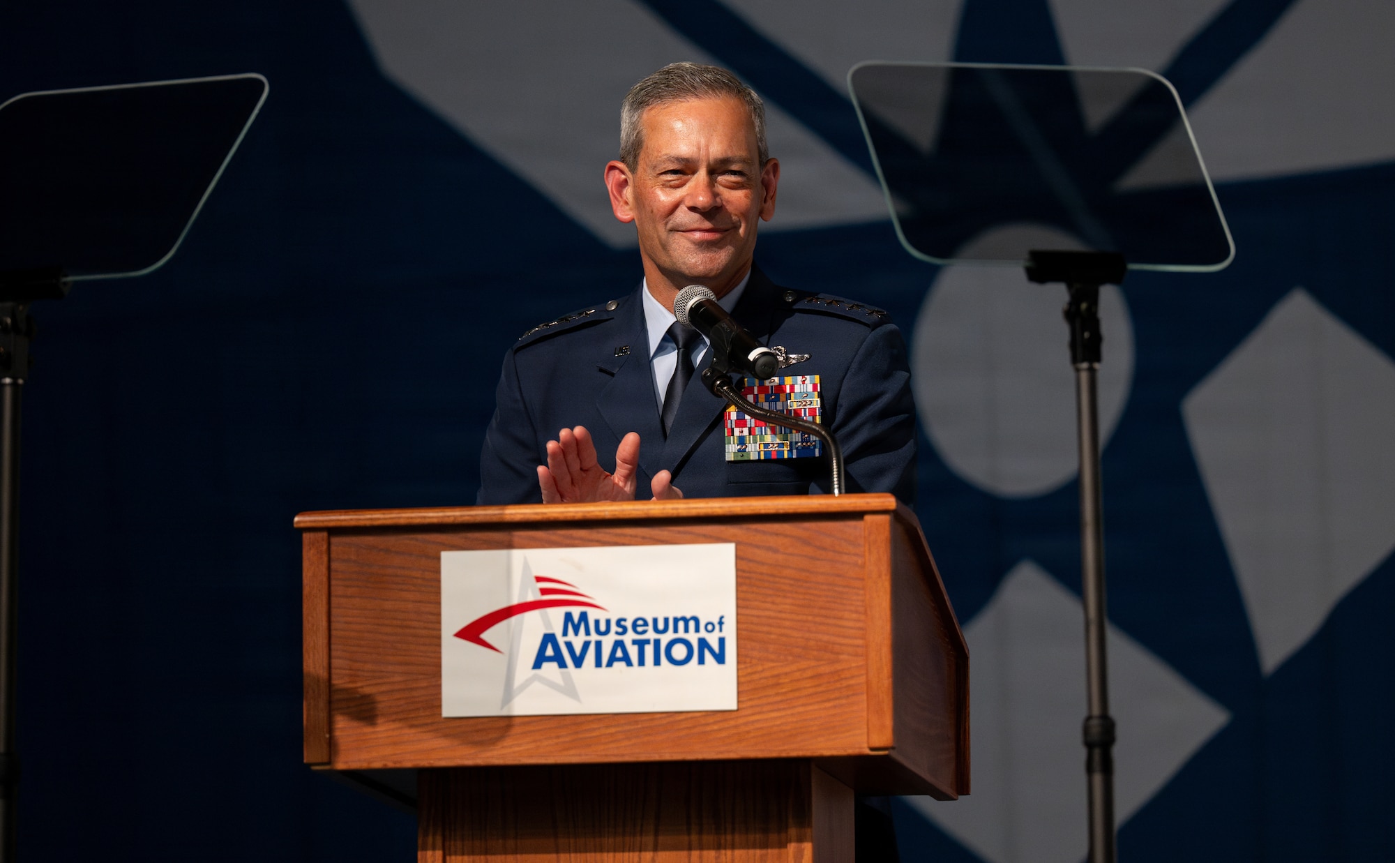 Air Force Chief of Staff Gen. Ken Wilsbach claps hands at podium