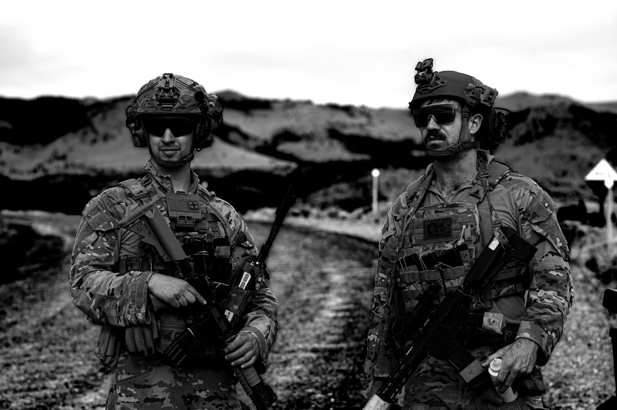 U.S. Air Force Senior Airman Mitchell Massa, 366th Civil Engineer Squadron (CES) explosive ordnance disposal (EOD) technician, and Airman 1st Class Levi Womack, 341st CES EOD technician, conduct a debrief after disabling a simulated explosive device during an exercise at Limestone Hills Training Area, Montana, Aug. 18, 2026. Debriefs after each problem let technicians evaluate their procedures and reinforce lessons learned before moving to the next scenario. (U.S. Air Force photo illustration by Tech. Sgt. Aaron Thomasson)