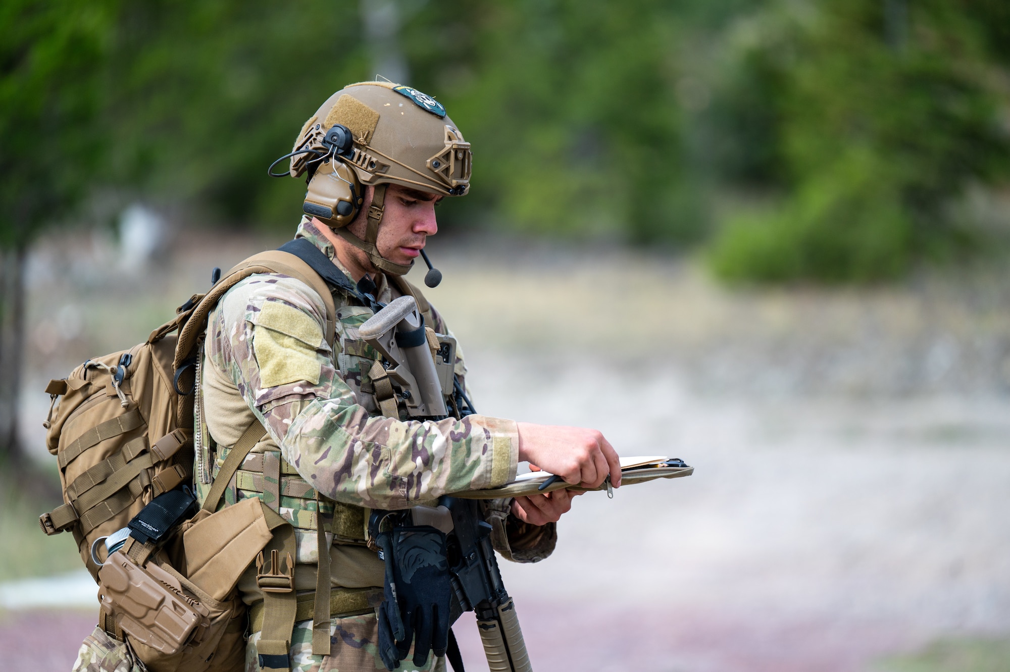 U.S. Air Force Airman 1st Class Jacob Miller-Lujan, 28th Civil Engineer Squadron explosive ordnance disposal (EOD) technician, makes notes on the next training task during an exercise at Limestone Hills Training Area, Montana, Aug. 18, 2026. Methodical planning and documentation are central to EOD work, where careful preparation reduces risk before a technician ever approaches a hazard. (U.S. Air Force photo by Tech. Sgt. Aaron Thomasson)