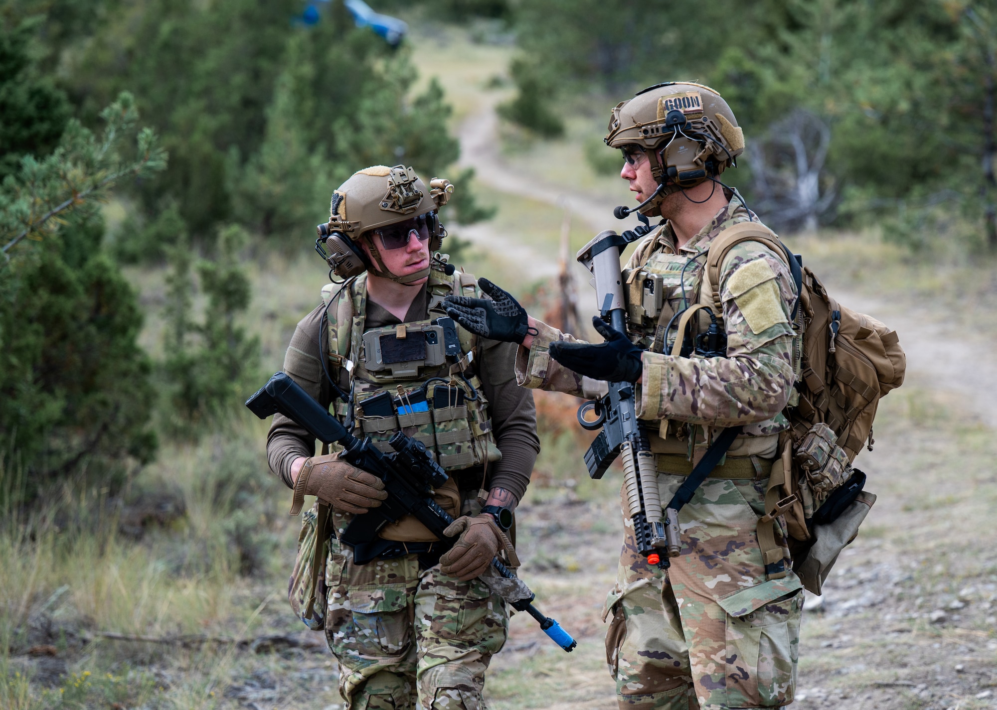 U.S. Air Force Staff Sgt. Hartvig Homberg, 341st Civil Engineer Squadron (CES) explosive ordnance disposal (EOD) technician, and Airman 1st Class Jacob Miller-Lujan, 28th CES EOD technician, discuss their plan for disabling multiple simulated explosive devices during an exercise at Limestone Hills Training Area, Montana, Aug. 18, 2026. Building a shared plan before approaching multiple devices ensures each technician understands their role and the sequence of render-safe actions. (U.S. Air Force photo by Tech. Sgt. Aaron Thomasson)