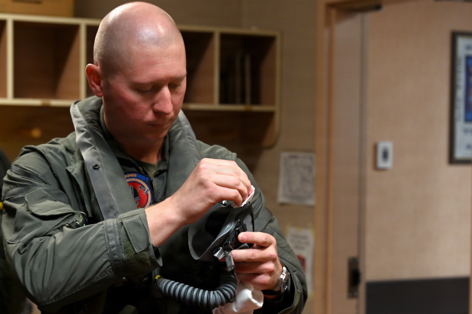 U.S. Marine Corps Maj. Zachary Vanwettering, Marine Fighter Attack Squadron 225 F-35B Lightning II pilot, sanitizes his mask before a flight at RED FLAG-Alaska 26-3 at Eielson Air Force Base, Alaska, Aug. 19, 2026.