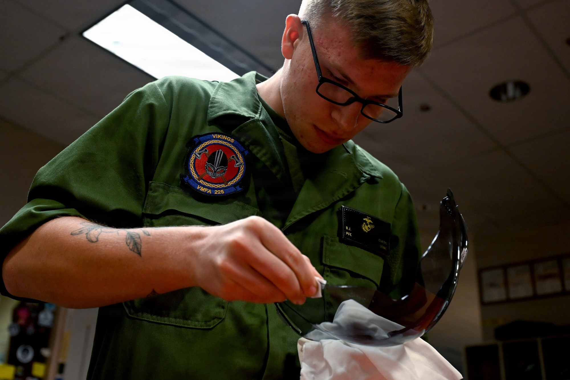 U.S. Marine Corps Pfc. Braden Curtis, Marine Fighter Attack Squadron 225 flight equipment technician, cleans the visor of a flight helmet during RED FLAG-Alaska 26-3 at Eielson Air Force Base, Alaska, Aug. 19, 2026.