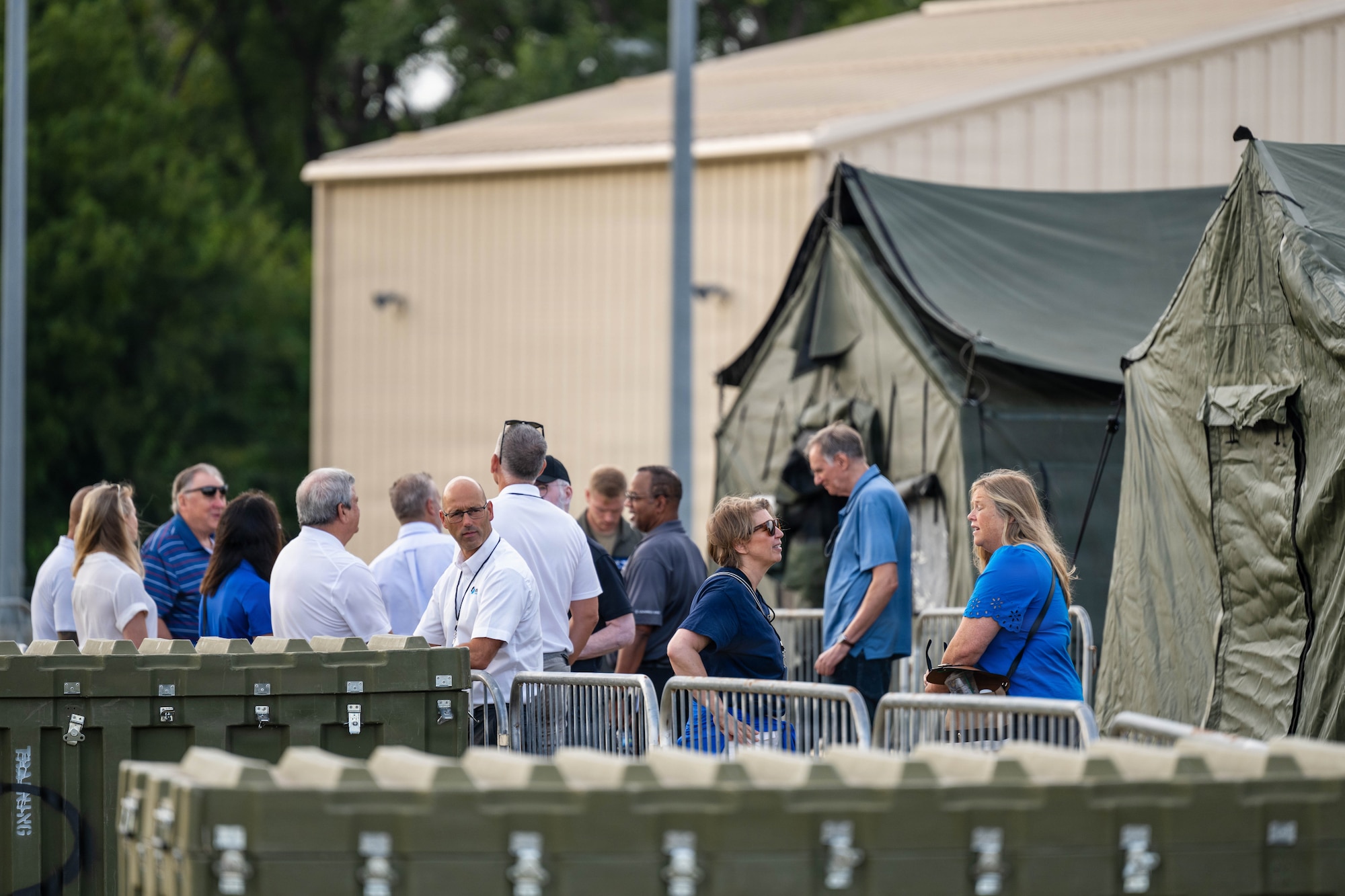 Industry leaders gather outside of tents during the Summer Industry Preview at McConnell Air Force Base, Kansas, Aug. 19, 2026. During the event, industry leaders and Airmen came together to explore the future of defense innovation and mission readiness. (U.S. Air Force photo by Senior Airman Patrick O’Neill)