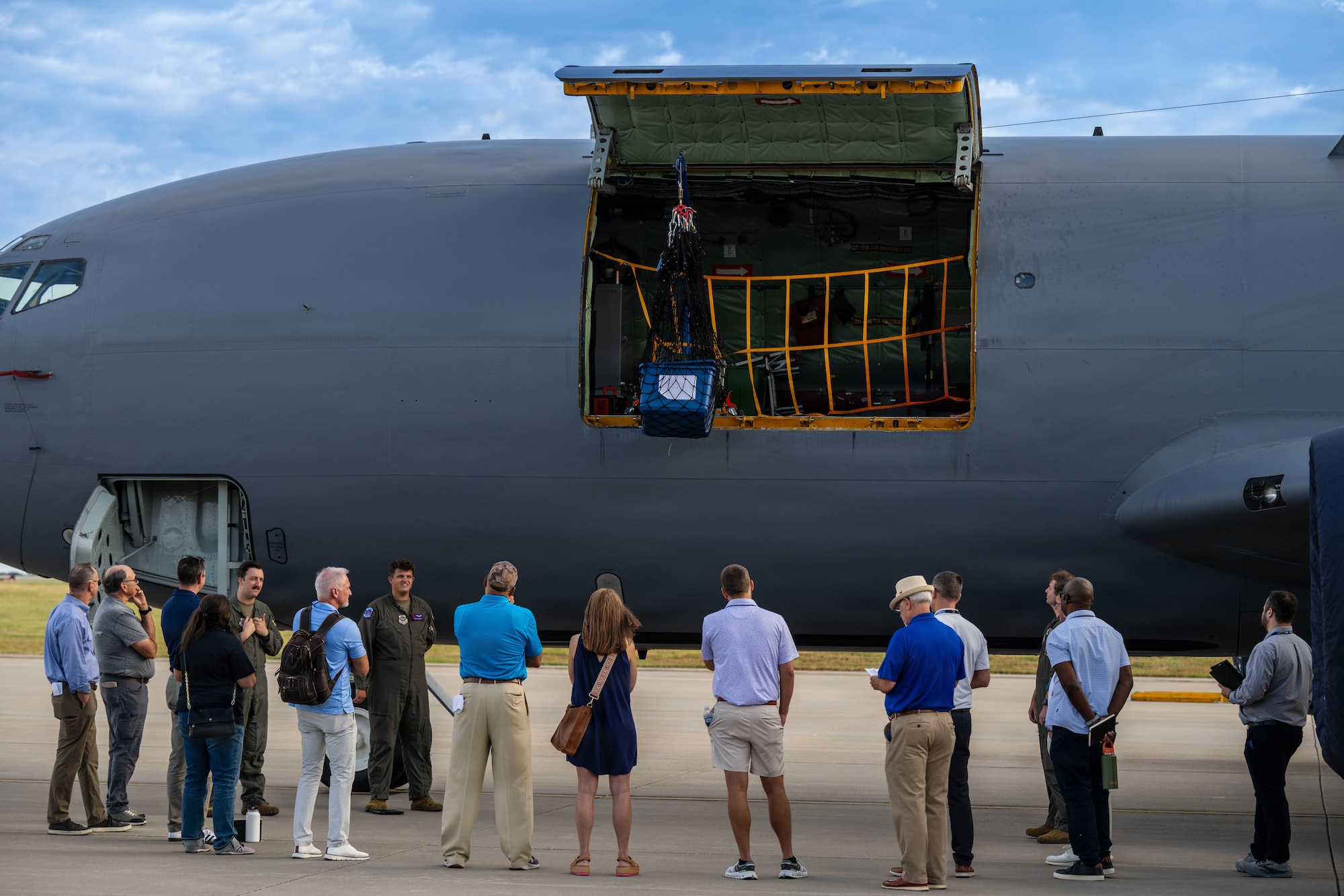 Summer Industry Preview participants gather beside a KC-135 Stratotanker for a demonstration on cargo loading at McConnell Air Force Base, Kansas, Aug. 19, 2026. These industry leaders were able to see dynamic industry prototypes and cutting-edge tech in action. (U.S. Air Force photo by Senior Airman Patrick O’Neill)