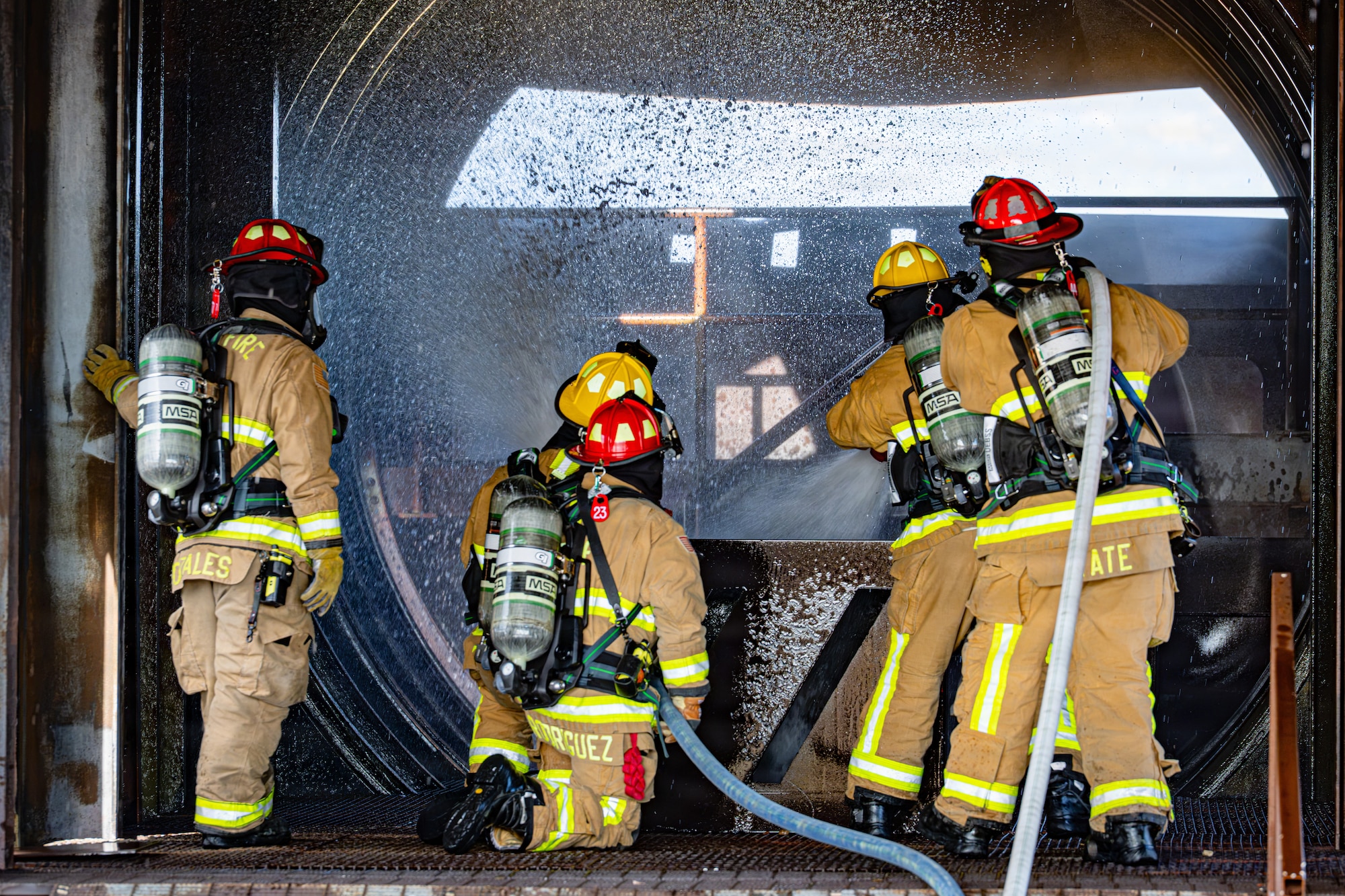Firefighters assigned to the 21st Civil Engineer Squadron conduct interior fire suppression during a full-scale emergency response exercise