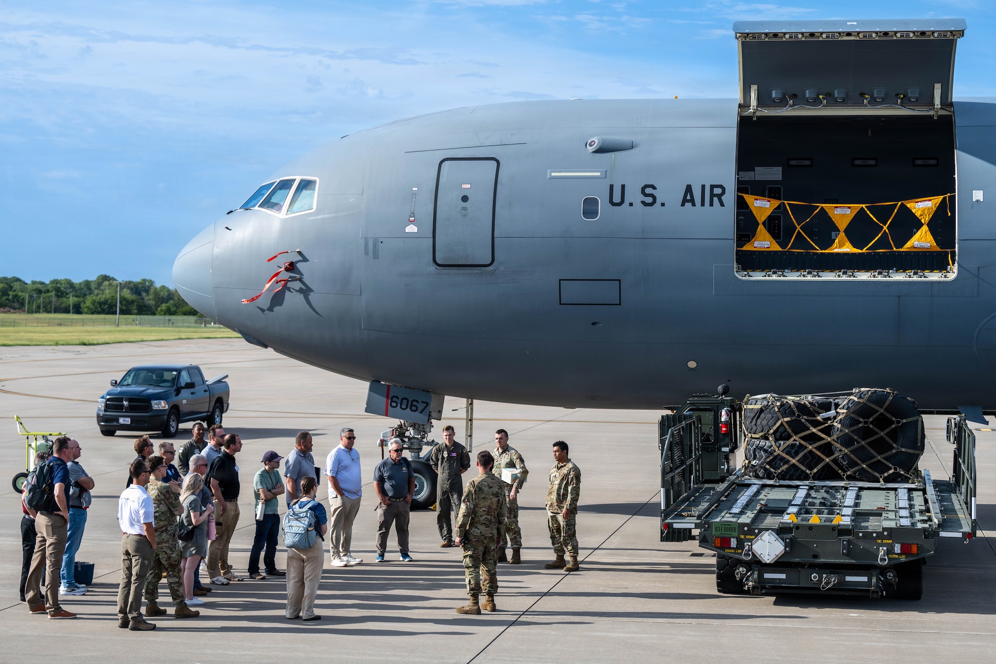 Summer Industry Preview participants gather beside a KC-46A Pegasus for a demonstration on cargo loading at McConnell Air Force Base, Kansas, Aug. 19, 2026. During the event, industry leaders got a behind-the-scenes look at the tech, talent, and partnerships shaping modern operations at McConnell. (U.S. Air Force photo by Senior Airman Patrick O’Neill)