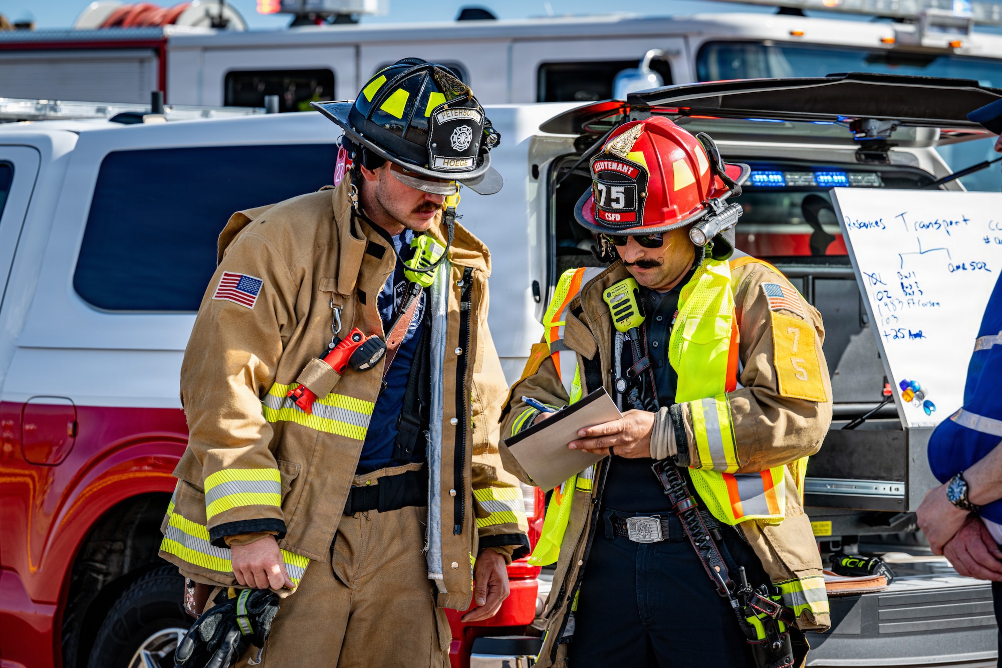 U.S. Air Force Staff Sgt. Isaiah Hoege, left, 21st Civil Engineer Squadron firefighter, coordinates with a Colorado Springs Fire Department firefighter