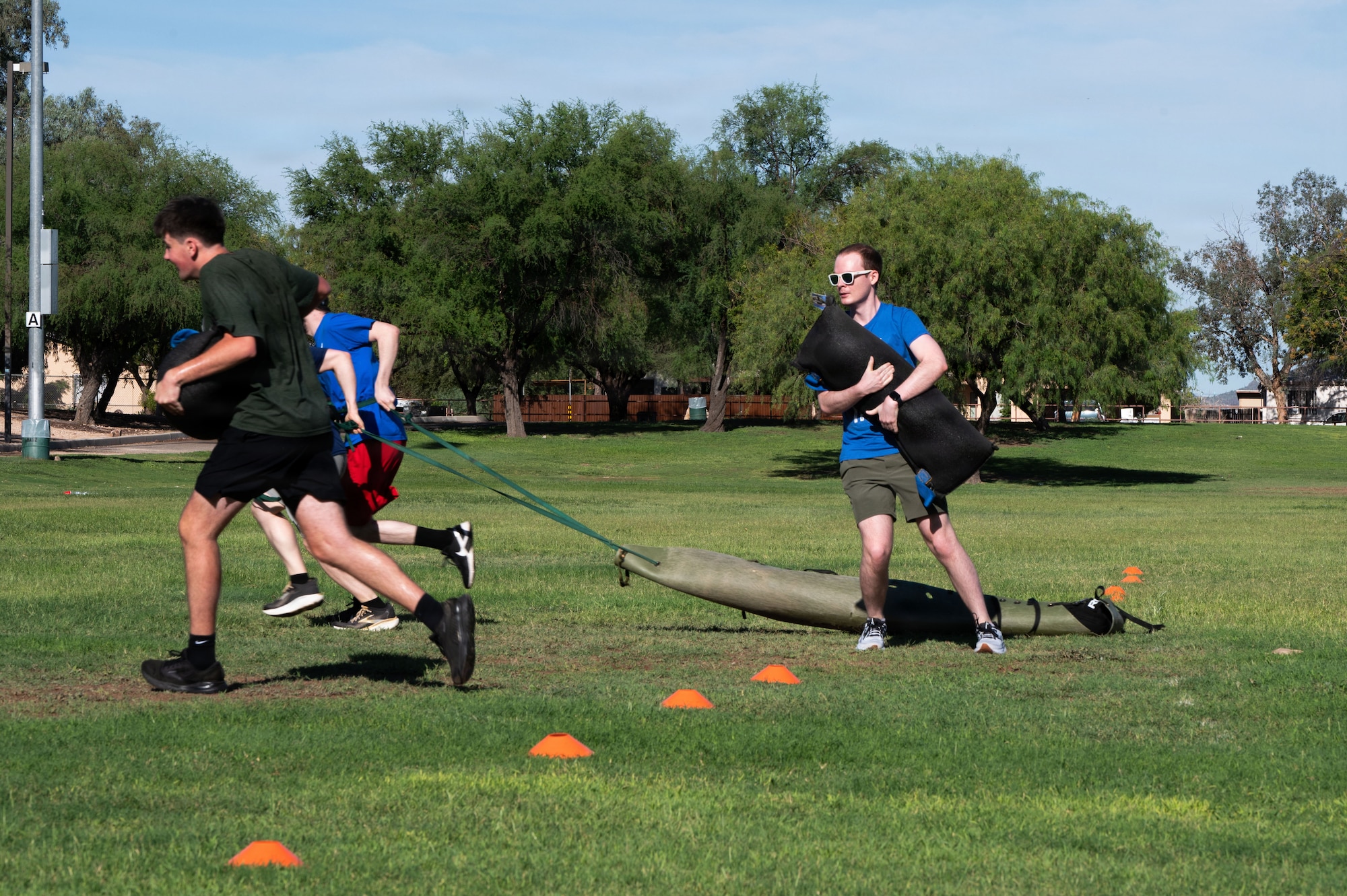 U.S. Air Force Delayed Entry Program (DEP) recruits carry sandbags and drag simulated casualties as part of a Special Warfare training day Aug. 20, 2026 at Silverlake Park in Tucson, Arizona. Recruits were assigned to one of six stations and were tasked to complete a workout circuit while alternating every 30 seconds and working with a team of four to finish each respective exercise. (U.S. Air Force photo by Airman Najzee Kuzu)