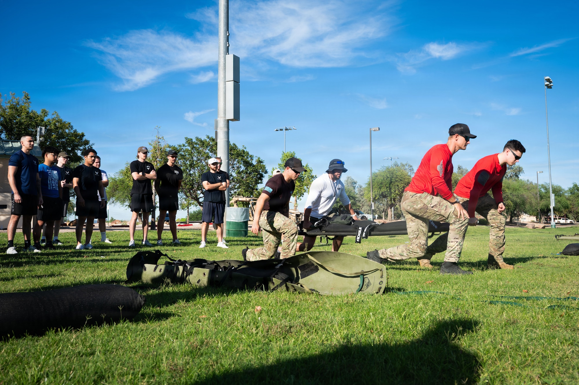 U.S. Airmen assigned to the 48th Rescue Squadron and the 68th RQS demonstrate an exercise to Air Force Delayed Entry Program (DEP) recruits, Aug. 20th, 2026 at Silverlake Park in Tucson, Arizona. The 48th and 68th RQS organized a Special Warfare themed physical training session as part of the recruits DEP Call for the month of August. (U.S. Air Force photo by Airman Najzee Kuzu)