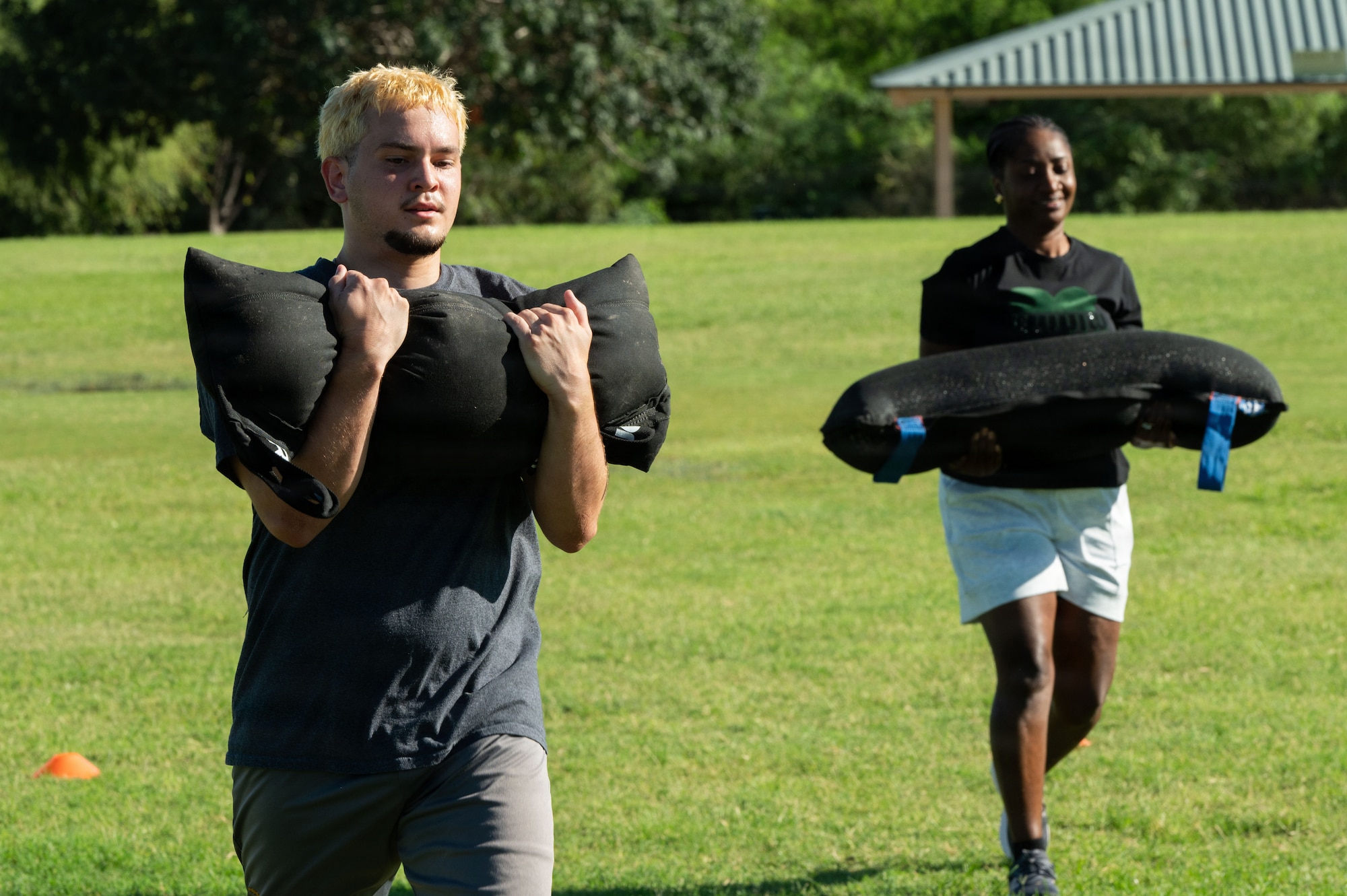 U.S. Air Force Delayed Entry Program recruits carry sandbags as part of a physical training session with the 48th Rescue Squadron and the 68th Rescue Squadron Aug. 20, 2026 at Silverlake Park in Tucson, Arizona. Airmen, recruits and leadership from the 362nd Recruiting Squadron showcased a variety of training exercises to highlight the importance of continued physical fitness and provide insight on the rescue career field. (U.S. Air Force photo by Airman Najzee Kuzu)