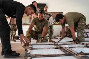 Members of the Massachusetts National Guard move floor tiles during construction and renovation work at Centro de Entrenamiento Conjunto de Operaciones de Paz (CECOPAZ), the Joint Peace Operations Training Center, in Asunción, Paraguay, July 16, 2026.