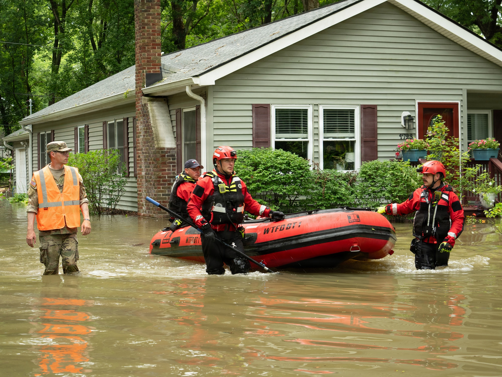 Indiana National Guardsmen with the 113th Engineer Battalion assist the Indianapolis Fire Department with flood evacuations Aug. 15, 2026, in response to devastating storms that swept through Indiana.