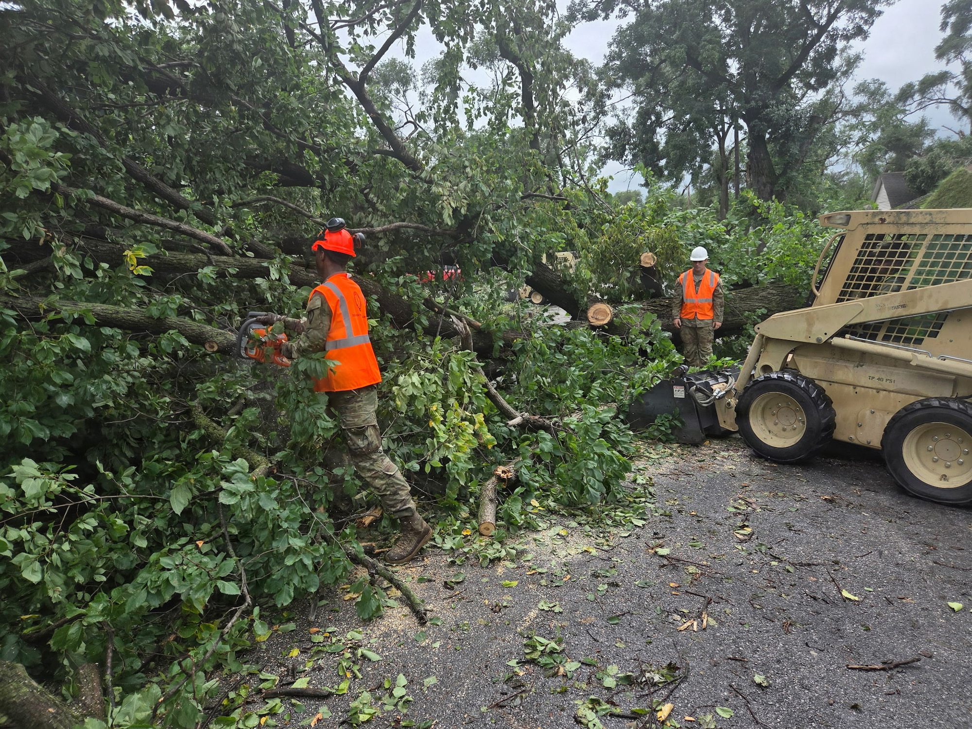 Indiana National Guardsmen with 113th Engineer Battalion clear arboreal debris in Gary, Indiana, in response to devastating storms that swept through the state Aug. 14, 2026.