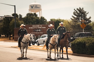 The 97th Air Mobility Wing command team rides in the 28th Annual Cattle Drive at Altus Air Force Base, Oklahoma, Aug. 20, 2026. Beyond celebrating the region's ranching heritage, the event highlights the enduring partnership between the base and the surrounding southwest Oklahoma community. (U.S. Air Force photo by Senior Airman Jonah Bliss)