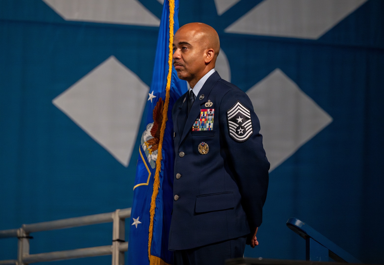 Chief Master Sgt. Israel Nunez, Air Force Reserve Command command chief, stands holding the guidon
