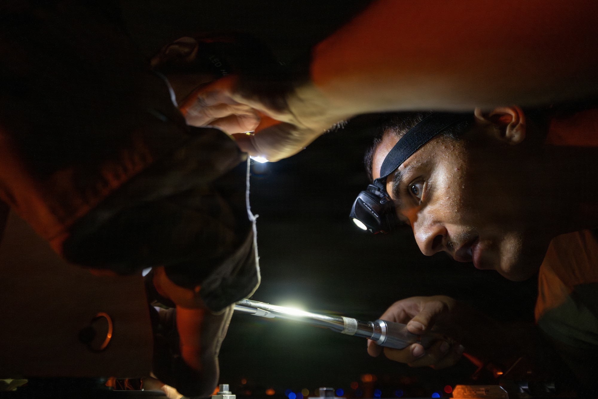 U.S. Air Force Airman 1st Class Lance Toland, 325th Aircraft Maintenance Squadron weapons load crew member, places an adaptor onto a munition during Weapons System Evaluation Program-West 26.07 at Hill Air Force Base, Utah, Aug. 12, 2026.