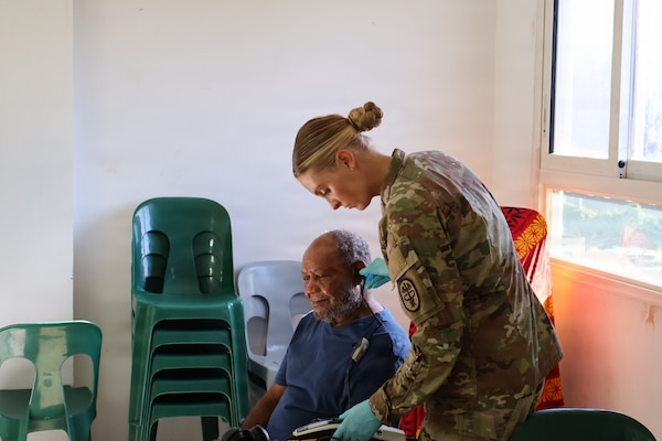 Capt. Alexandra Morgan, Chief of Hearing Conservation, Triple Army Medical Center, provides a hearing test to a Solomon Islands community member. (Photo by Staff Sgt. Susana Castillo)
