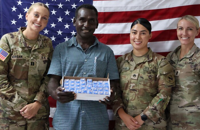 Tripler Army Medical Center and Oceania Engagement Team personnel present Obiga Newton, Solomon Islands ENT Clinic Nurse and Audiometrist, with a donation of hearing protection. (Photo by Staff Sgt. Susana Castillo)