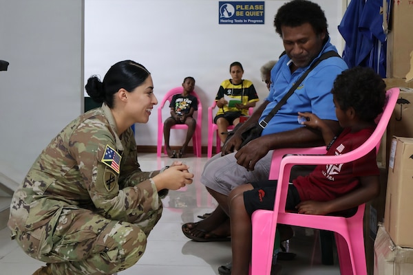 HONIARA, Solomon Islands.-Staff Sgt. Susana Castillo, Team Sergeant, USARPAC Oceania Engagement Team, distributes hearing protection. (Photo by Staff Sgt. Susana Castillo)