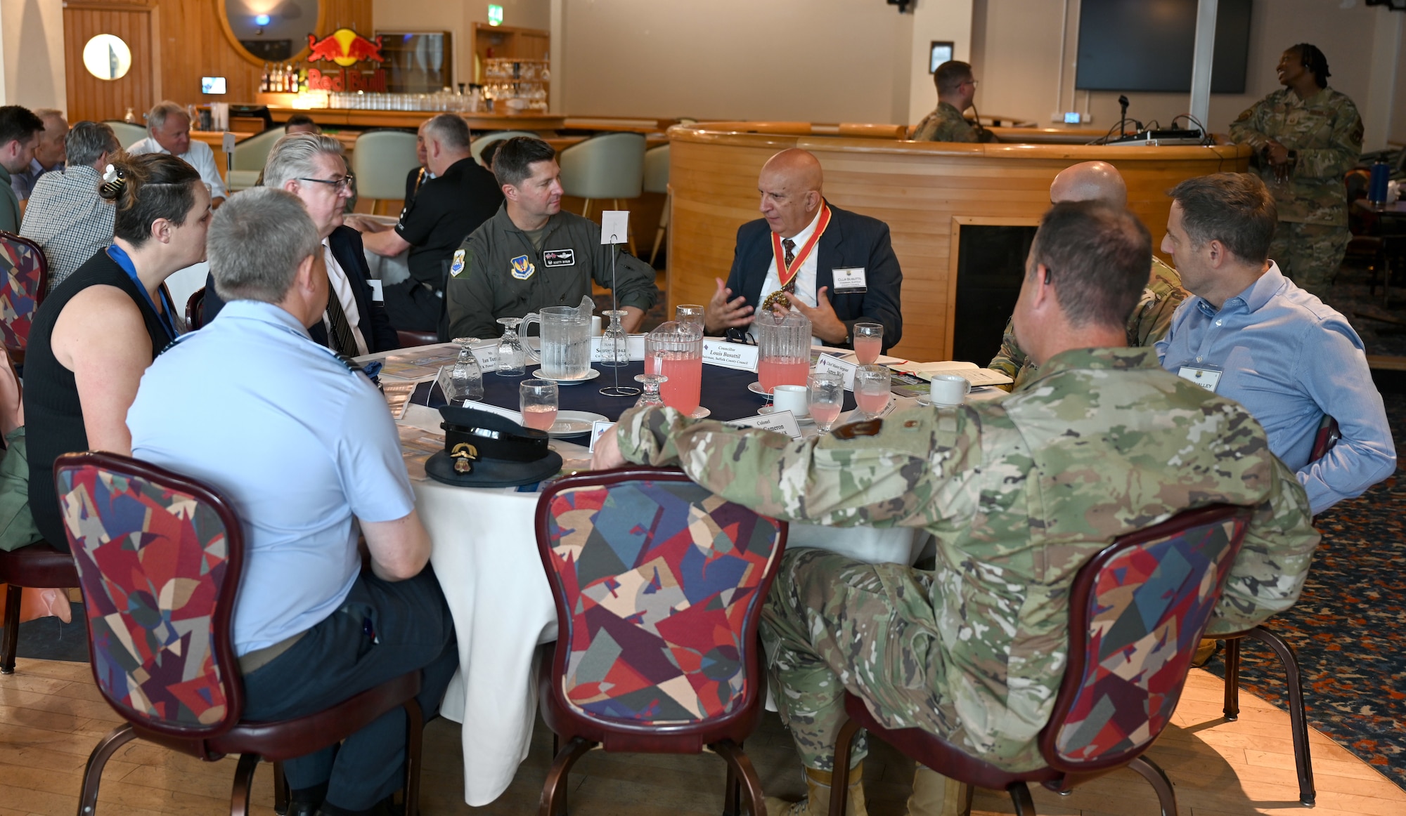 Councillor Louis Busuttil, center, Suffolk County Council chairman, speaks with Team Mildenhall leaders, local civic leaders and key service providers from Suffolk, Norfolk and Cambridgeshire during the Key Leaders Engagement Day at RAF Mildenhall, England, Aug. 20, 2026. The guests viewed base facilities, engaged with Team Mildenhall Airmen and civilians, and saw advanced military assets which execute our global mission every day. (U.S. Air Force photo by Karen Abeyasekere)