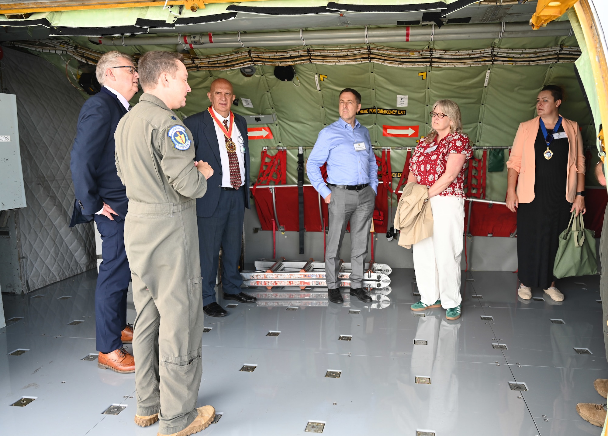 U.S. Air Force Lt Col Justin Kellett, front, 351st Air Refueling Squadron commander, discusses the capabilities of the KC-135 Stratotanker to local civic leaders and key service providers from Suffolk, Norfolk and Cambridgeshire during the Key Leaders Engagement Day at RAF Mildenhall, England, Aug. 20, 2026. The civic leaders and service providers viewed base facilities, engaged with Team Mildenhall Airmen and civilians, and saw advanced military assets which execute our global mission every day. (U.S. Air Force photo by Karen Abeyasekere)