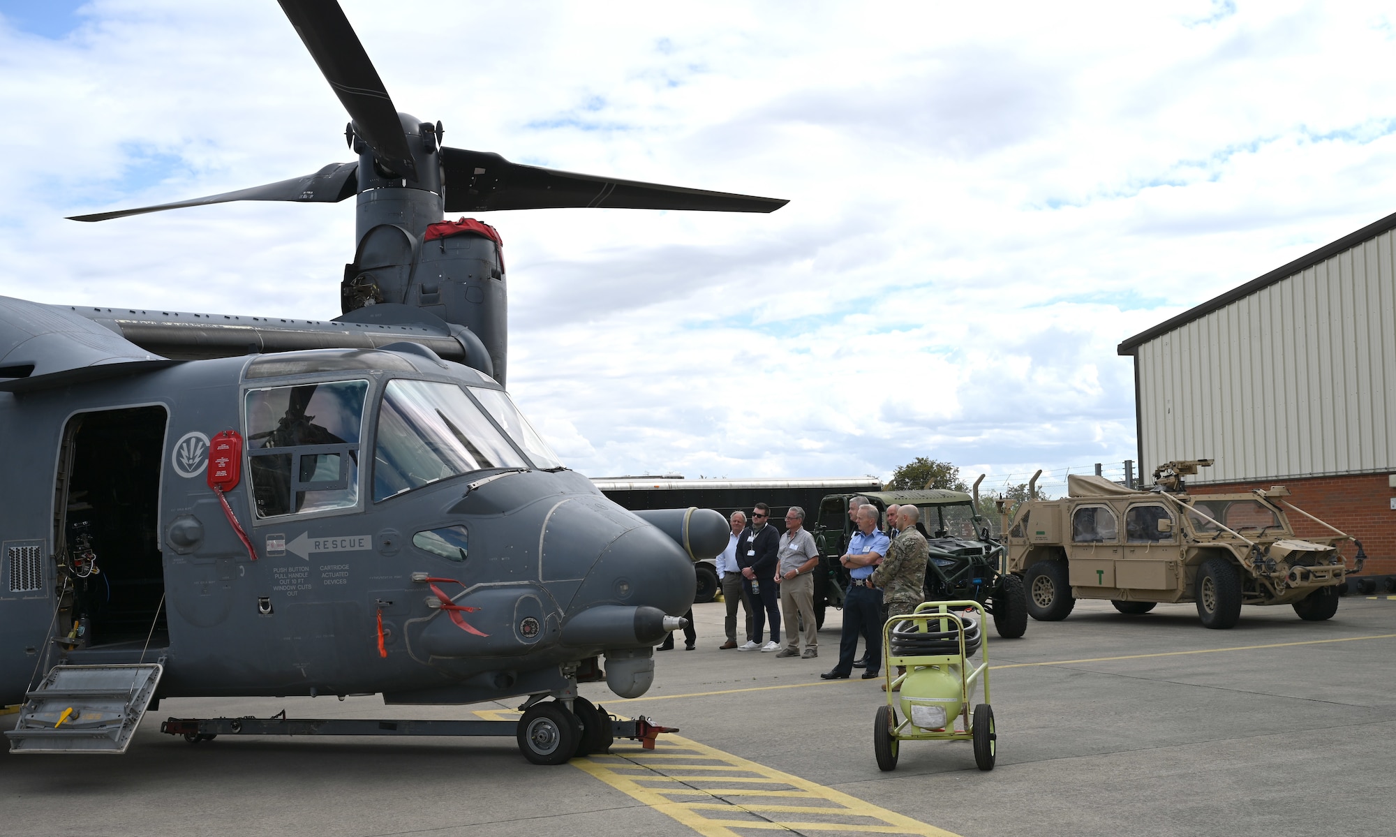 Local civic leaders and key service providers from Suffolk, Norfolk and Cambridgeshire are briefed on the capabilities of a CV-22 Osprey, assigned to the 7th Special Operations Squadron, during the Key Leaders Engagement Day at RAF Mildenhall, England, Aug. 20, 2026. The guests viewed base facilities, engaged with Team Mildenhall Airmen and civilians, and saw advanced military assets which execute our global mission every day. (U.S. Air Force photo by Karen Abeyasekere)