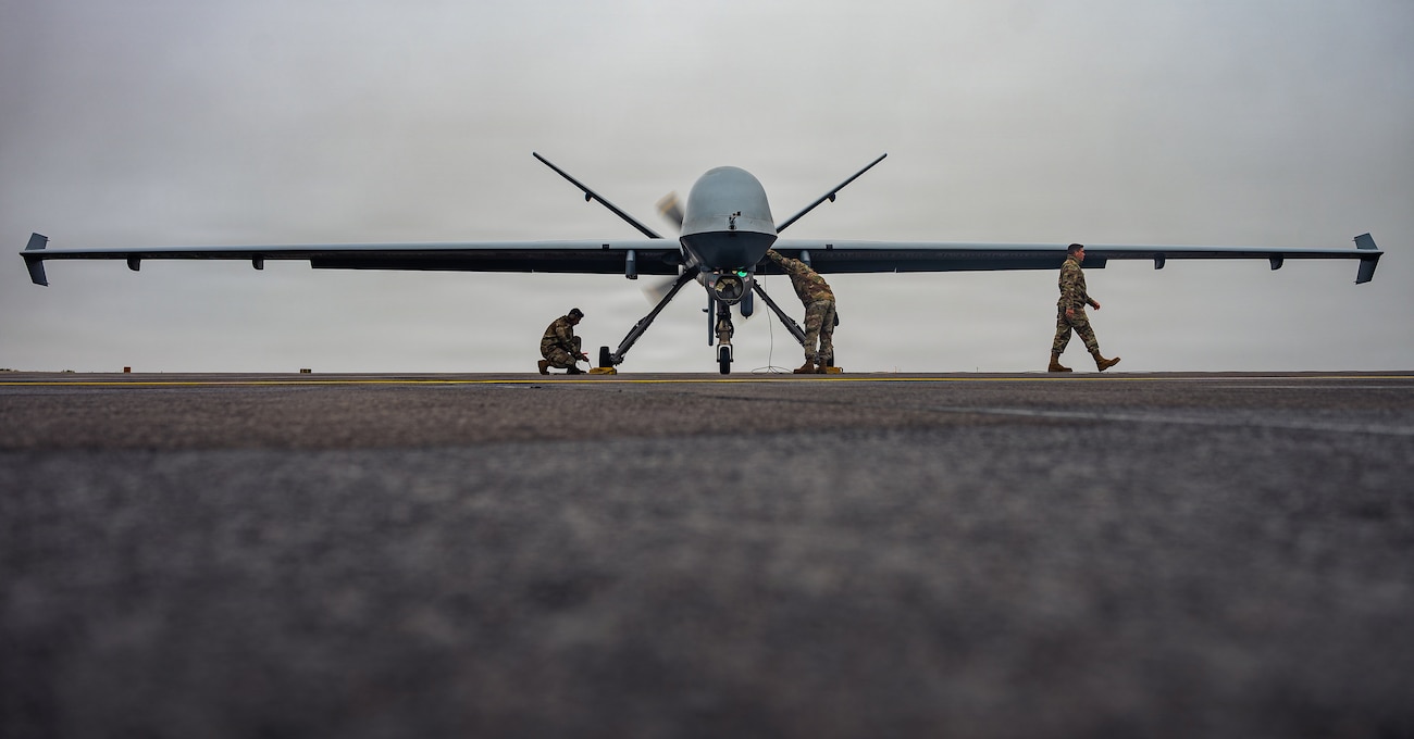 U.S. Air Force Airmen assigned to the 147th Aircraft Maintenance Squadron perform postflight checks on an MQ-9 Reaper drone assigned to the 147th Attack Wing, Texas Air National Guard, at Keflavík Air Base, Iceland, during exercise Northern Viking 26
