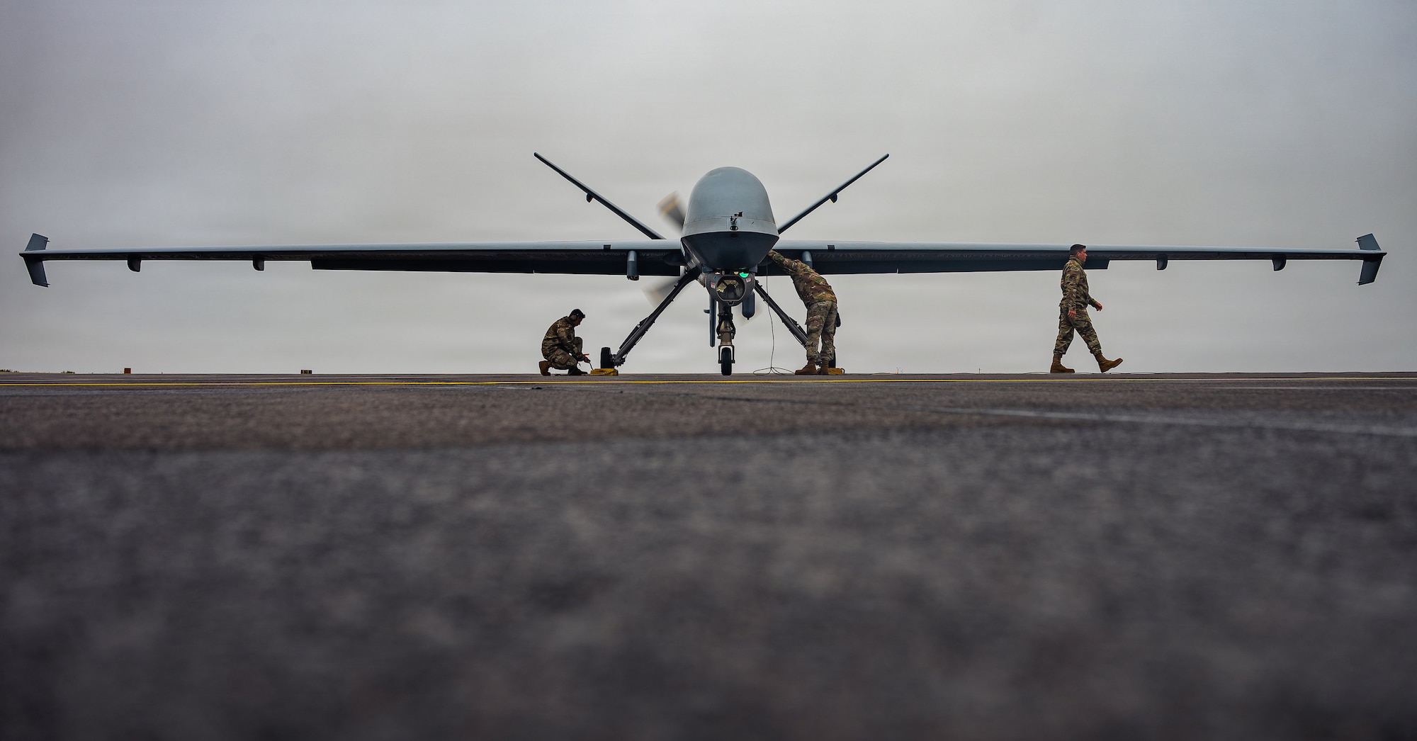 U.S. Air Force Airmen assigned to the 147th Aircraft Maintenance Squadron perform postflight checks on an MQ-9 Reaper drone assigned to the 147th Attack Wing, Texas Air National Guard, at Keflavík Air Base, Iceland, during exercise Northern Viking 26