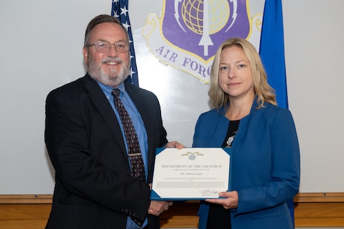 Image of person presenting certificate to another person.
