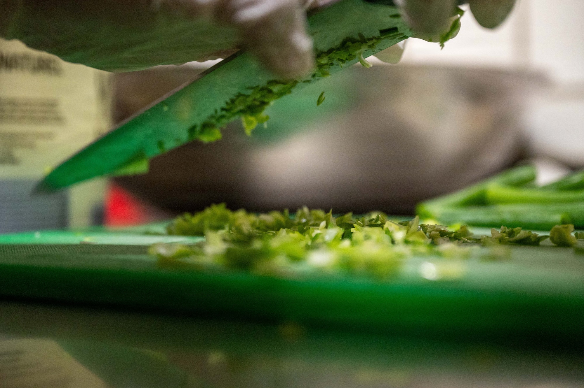 A competitor cuts a green onion during the 786th Force Support Squadron Wing Wars competition at Kapaun Air Station, Germany, Aug. 19, 2026.