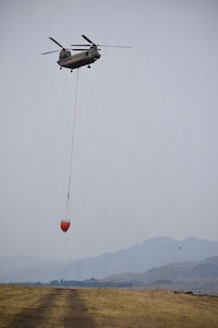 A CH-47 Chinook Helicopter hoovers near the Army Aviation Support Facility 2 at Pangborn Memorial Airport, East Wenatchee, Wash., August 16, 2026.