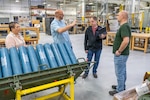 Quality Management Specialist Wayne Daniels (second from left) describes Tobyhanna's processes to auditor David Nelson (second from right). (U.S. Army photo by Justin Kucharski)