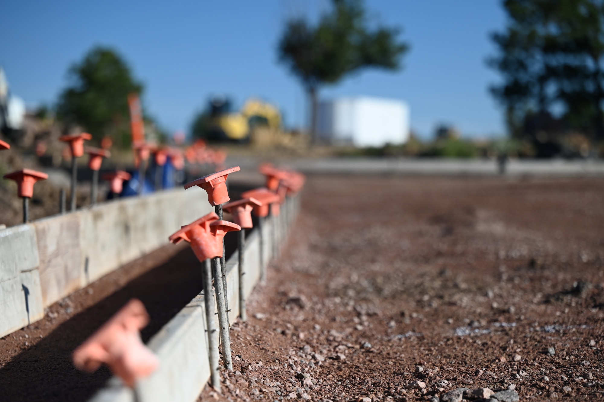 A landscape photo of rebar safety caps used at the Enoch Gate road construction on Schriever Space Force Base