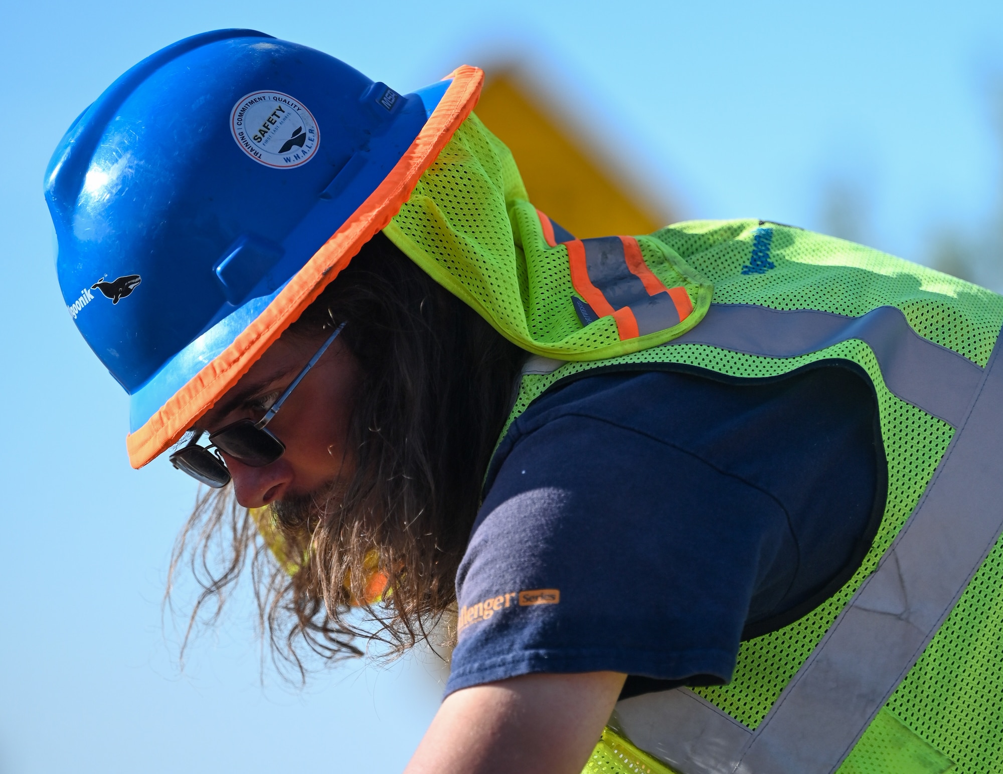 A construction worker assists in Enoch Gate road construction on Schriever Space Force Base.