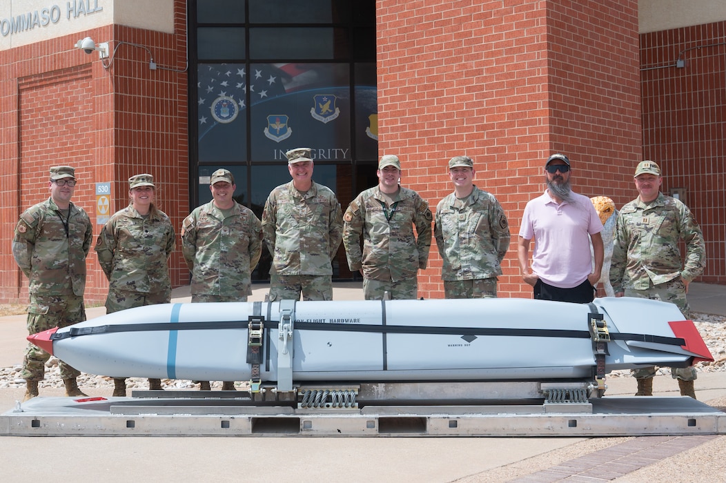 Members from Team Goodfellow pose for a group photo with a Dummy Air Training Munition 158A missile during its delivery to the 315th Training Squadron at Goodfellow Air Force Base, Texas, Aug. 19, 2026. The 315th TRS received the DATM-158A to provide intelligence, surveillance and reconnaissance professionals with a hands-on training experience that connects classroom targeting concepts to a simulated munition. (U.S. Air Force photo by Senior Airman Brian Lummus)
