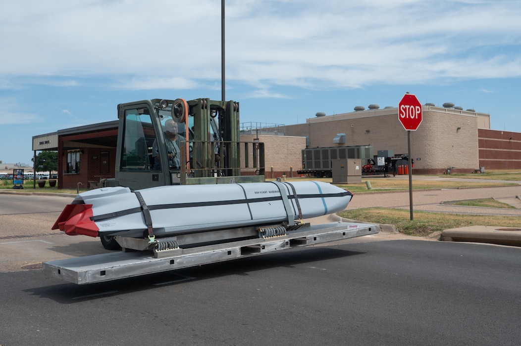 Dustin Bresko, 17th Logistics Readiness Squadron munitions inspector, uses a forklift to transport a Dummy Air Training Munition 158A missile during its delivery to the 315th Training Squadron at Goodfellow Air Force Base, Texas, Aug. 19, 2026. Air Force Material Command provided the DATM-158A to give intelligence, surveillance and reconnaissance professionals a physical representation of weapon systems they may only encounter through classroom materials before reaching an operational unit otherwise. (U.S. Air Force photo by Senior Airman Brian Lummus)