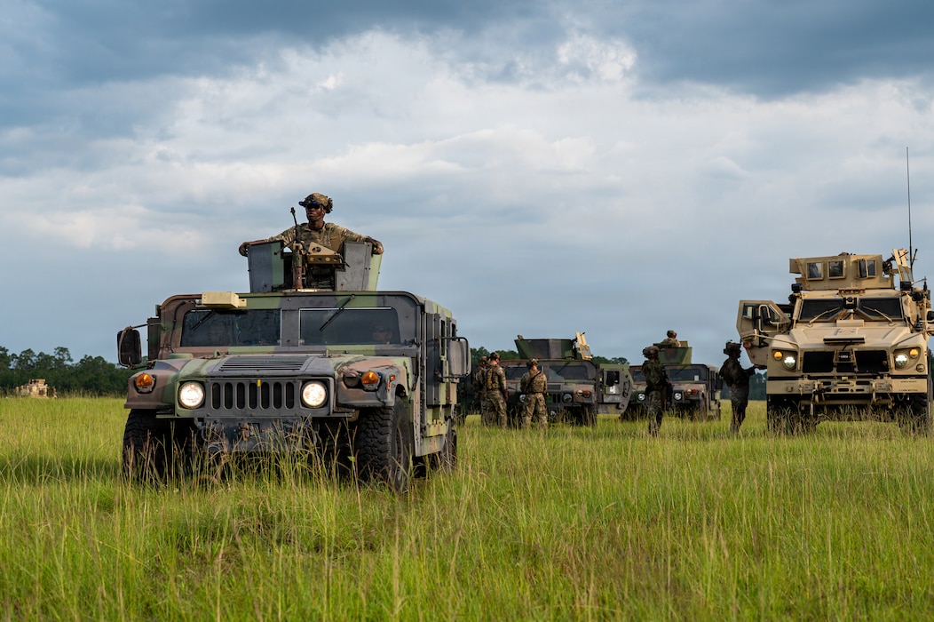 Military vehicles in a line.