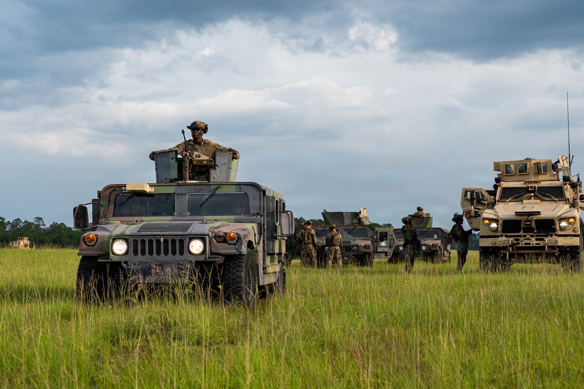 Military vehicles in a line.