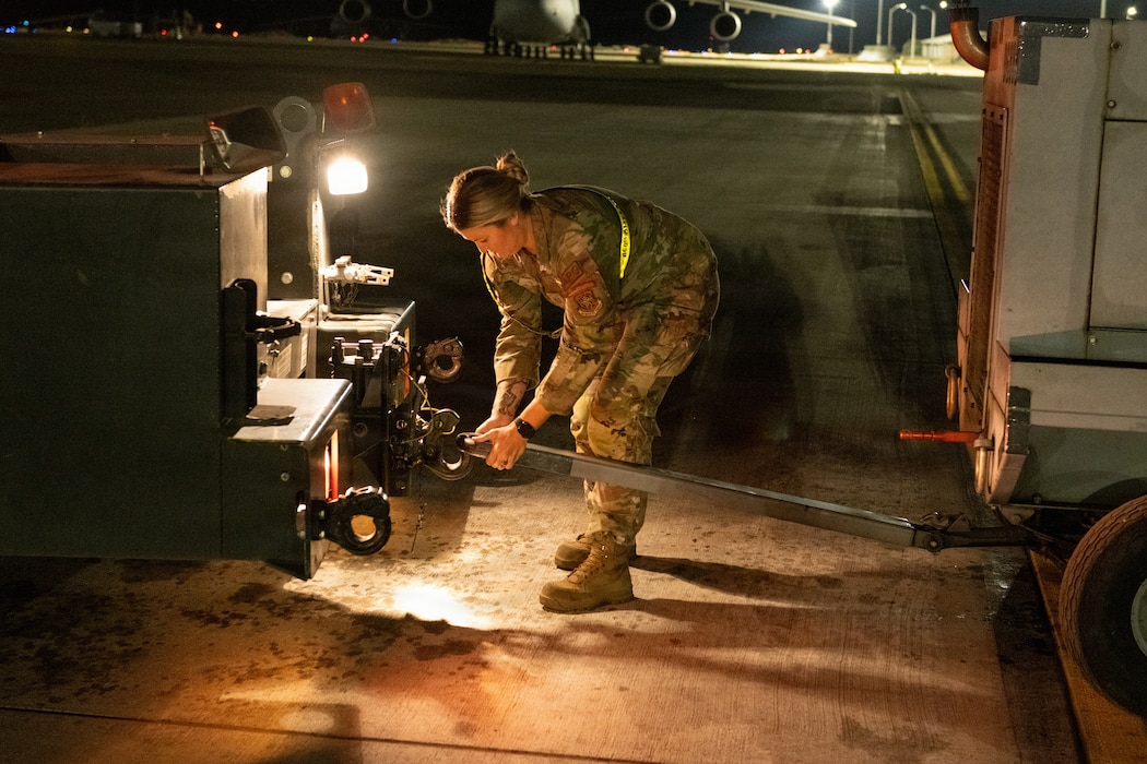 Airman hooks power cart to truck