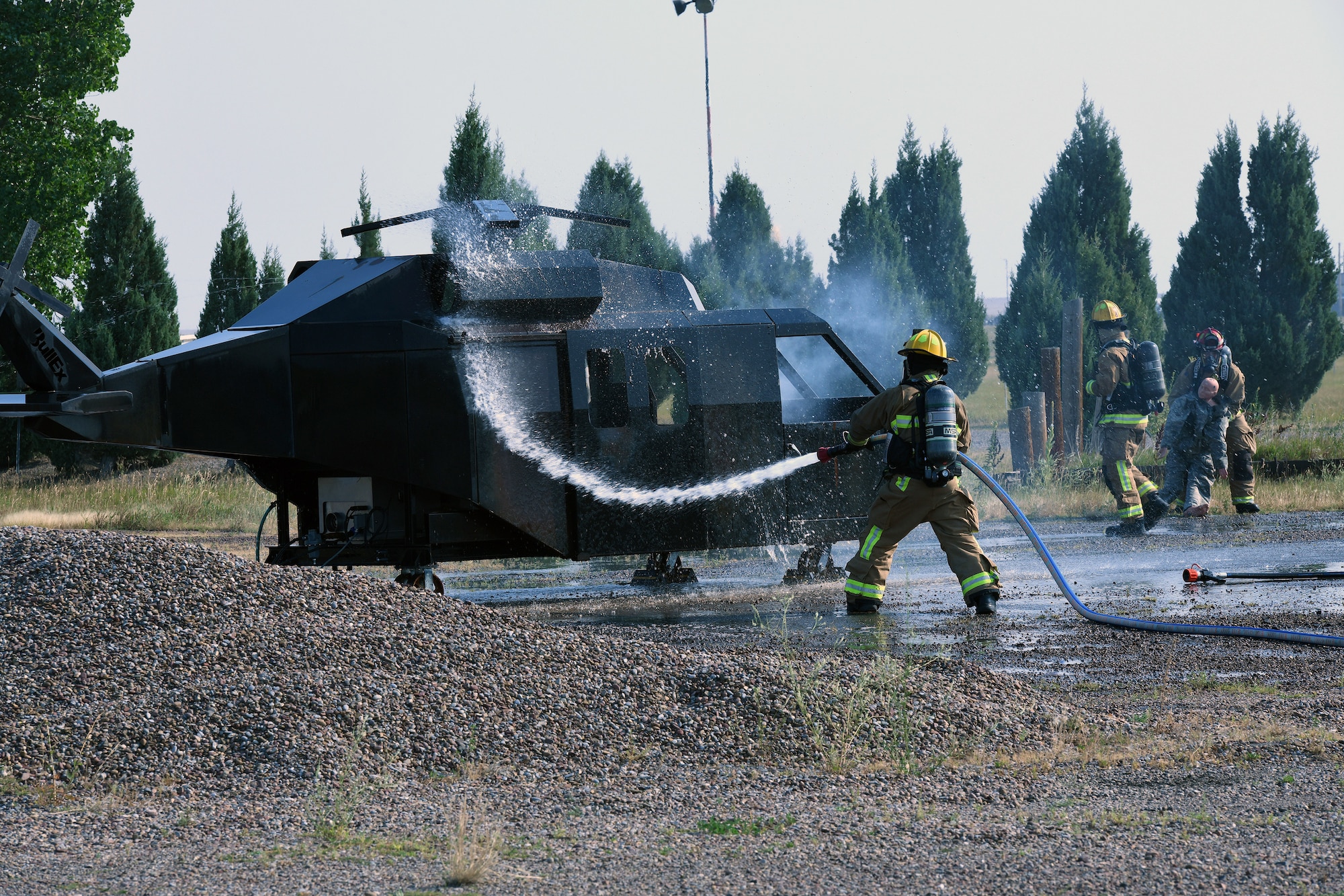 Malmstrom AFB firefighters with the 341st Civil Engineer Squadron hose off a simulated crashed MH-139A Grey Wolf Helicopter during a Mass Accident Response Exercise at Malmstrom AFB.