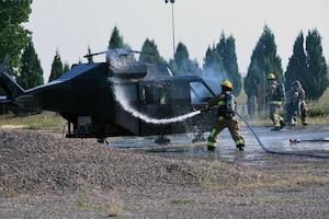 Malmstrom AFB firefighters with the 341st Civil Engineer Squadron hose off a simulated crashed MH-139A Grey Wolf Helicopter during a Mass Accident Response Exercise at Malmstrom AFB.